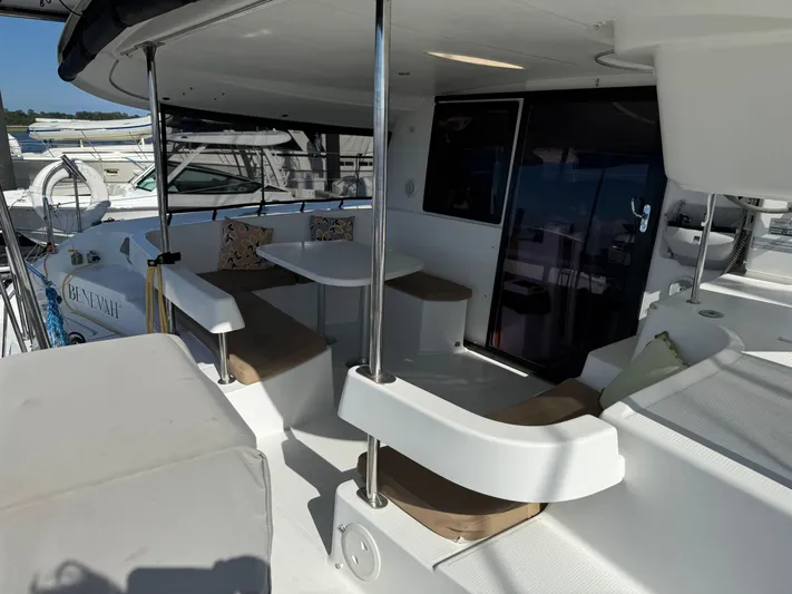 Benevah Yacht Photos Pics 2013 Fountaine Pajot Lipari 41 catamaran cockpit with seating and table, docked at marina.