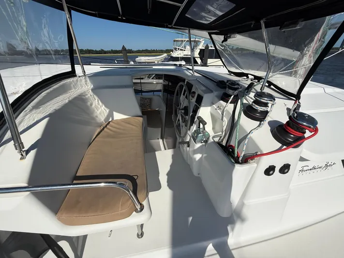 Benevah Yacht Photos Pics Helm station of 2013 Fountaine Pajot Lipari 41 catamaran with seating and steering wheel.