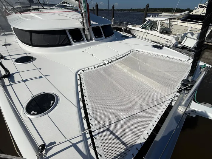 Benevah Yacht Photos Pics 2013 Fountaine Pajot Lipari 41 catamaran with spacious deck and netting, docked at marina.