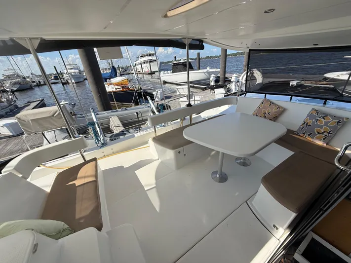 Benevah Yacht Photos Pics 2013 Fountaine Pajot Lipari 41 catamaran with spacious outdoor seating and table, docked at marina.