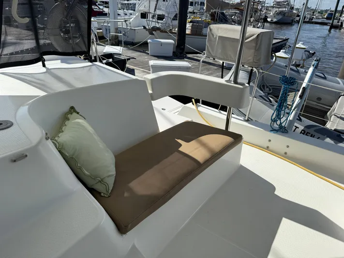 Benevah Yacht Photos Pics Fountaine Pajot Lipari 41 catamaran deck with cushioned seating, docked at marina, 2013 model.