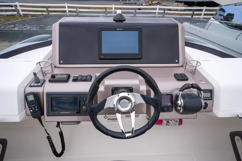  Yacht Photos Pics Galeon 43 SKY 2017 helm with steering wheel, navigation controls, and display screen.