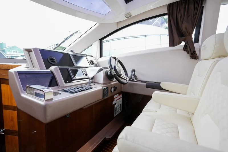  Yacht Photos Pics Interior of 2017 Galeon 43 SKY yacht cockpit with modern controls and plush seating.