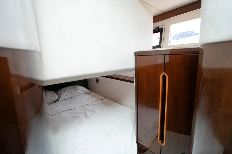  Yacht Photos Pics Cozy bedroom interior of 2017 Galeon 43 SKY yacht with wooden cabinetry.