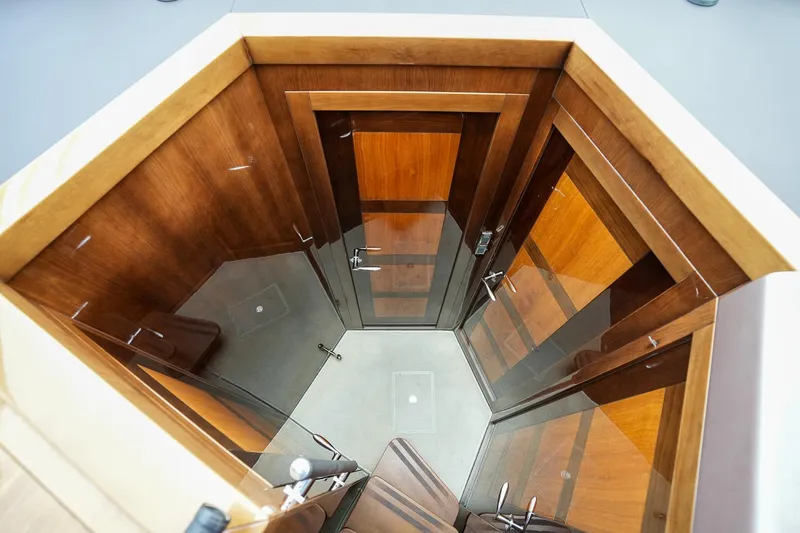  Yacht Photos Pics Interior view of 2017 Galeon 43 SKY yacht with wooden finishes and glass doors.