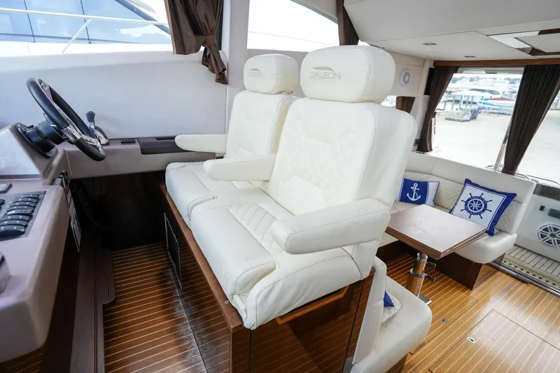  Yacht Photos Pics Luxurious interior of 2017 Galeon 43 SKY yacht with plush white seating and nautical decor.