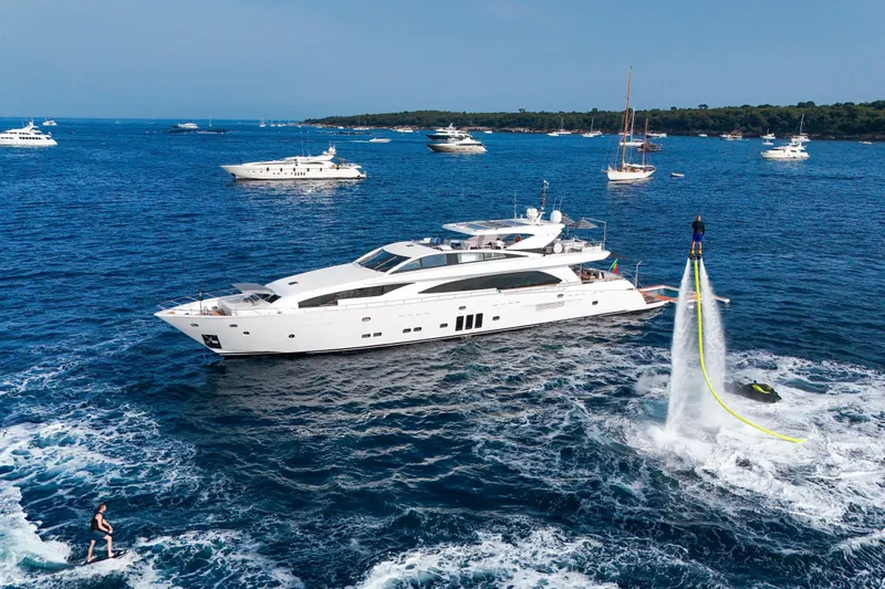 Millesime Yacht Photos Pics Luxurious 2020 Guy Couach 3700 Fly yacht with flyboarders in vibrant blue sea.