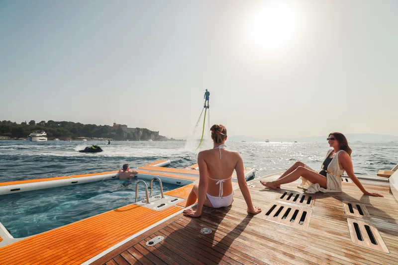 Millesime Yacht Photos Pics Luxury yacht Guy Couach 3700 Fly, 2020 model, with people enjoying water activities.