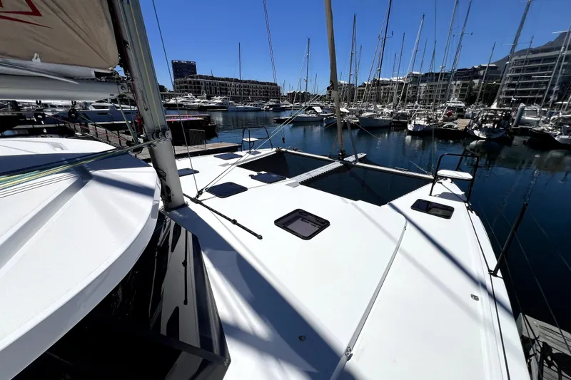 Polpo Yacht Photos Pics 2025 Balance 482 yacht docked in a marina, surrounded by sailboats under clear blue sky.
