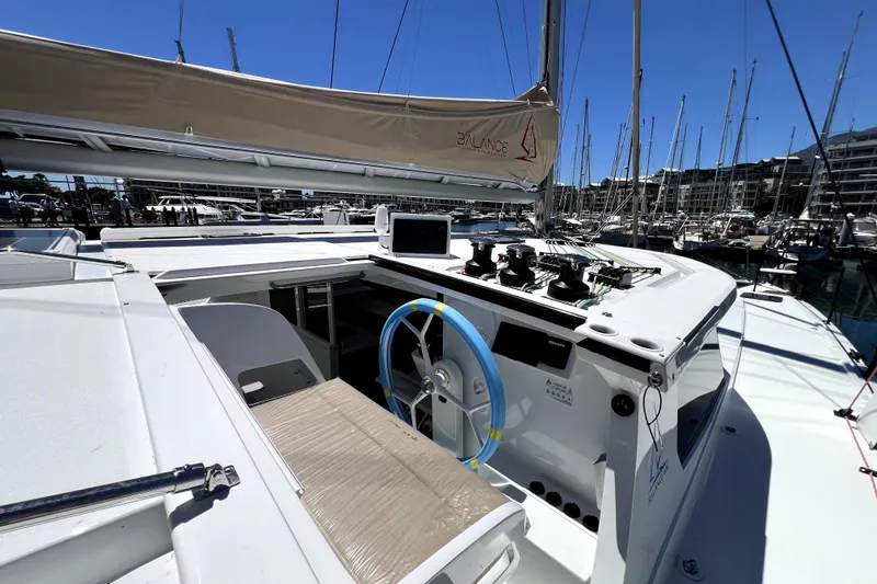 Polpo Yacht Photos Pics Modern Balance 482 sailboat cockpit with blue steering wheel, docked in a marina, 2025 model.