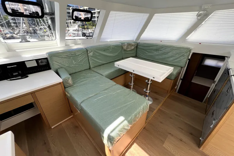 Polpo Yacht Photos Pics Luxurious interior of 2025 Balance 482 yacht with green seating and modern design.