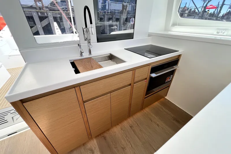 Polpo Yacht Photos Pics Modern yacht kitchen with sleek design, featuring wood cabinetry and built-in appliances, Balance 482, 2025.