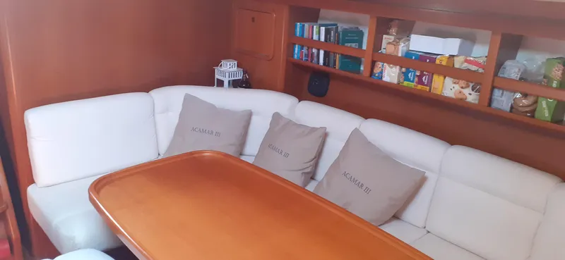 "acamar Iii" Yacht Photos Pics Interior of 1992 Grand Soleil 45 German Frers yacht with cozy seating and wooden table.