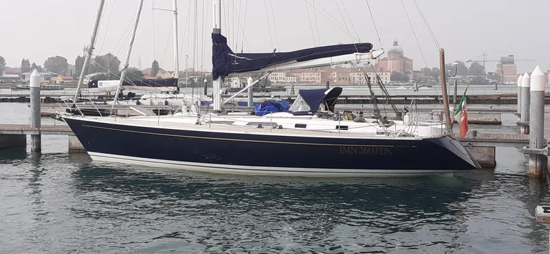 "acamar Iii" Yacht Photos Pics 1992 Grand Soleil 45 German Frers sailboat docked in a marina, side view.