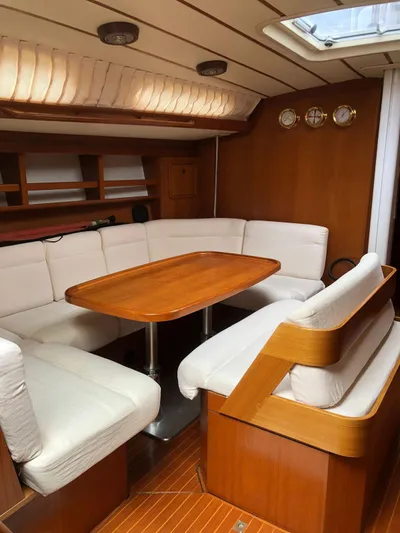 "acamar Iii" Yacht Photos Pics Interior of 1992 Grand Soleil 45 German Frers yacht with wooden table and white seating.