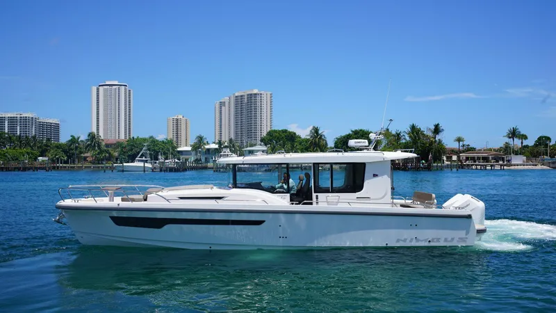 In-stock 2024 Nimbus C11 #082 Yacht Photos Pics 2024 Nimbus Commuter 11 #082 boat cruising near a city skyline.
