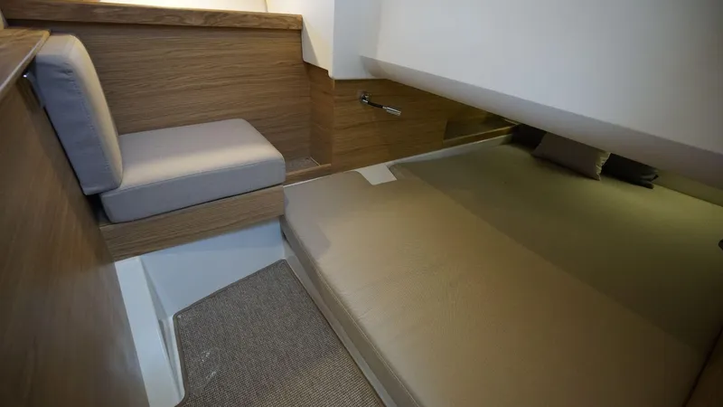 In-stock 2024 Nimbus C11 #082 Yacht Photos Pics 2024 Nimbus Commuter 11 #082 cabin interior with bed and seating area.