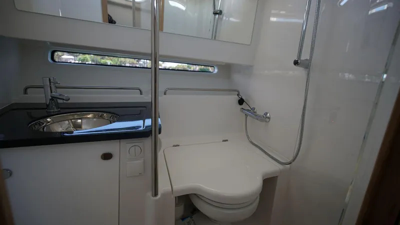 In-stock 2024 Nimbus C11 #082 Yacht Photos Pics 2024 Nimbus Commuter 11 #082 boat bathroom with sink, toilet, and shower.