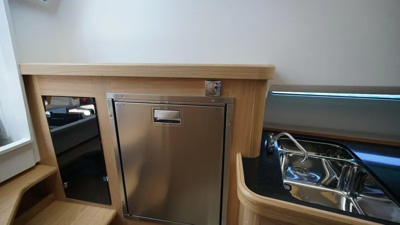 In-stock 2024 Nimbus C11 #082 Yacht Photos Pics Interior of 2024 Nimbus Commuter 11 #082 featuring stainless steel fridge and sink.