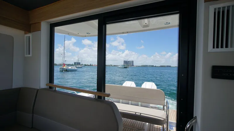 In-stock 2024 Nimbus C11 #082 Yacht Photos Pics View from inside a 2024 Nimbus Commuter 11 #082 boat, overlooking a serene waterfront.