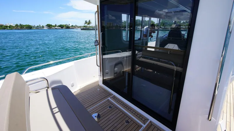 In-stock 2024 Nimbus C11 #082 Yacht Photos Pics 2024 Nimbus Commuter 11 #082 boat deck with seating and sliding glass door.