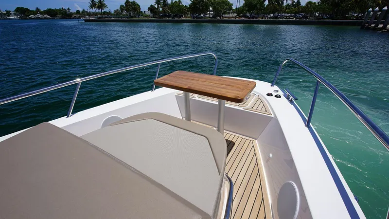 In-stock 2024 Nimbus C11 #082 Yacht Photos Pics Front deck of 2024 Nimbus Commuter 11 #082 boat with table and seating.