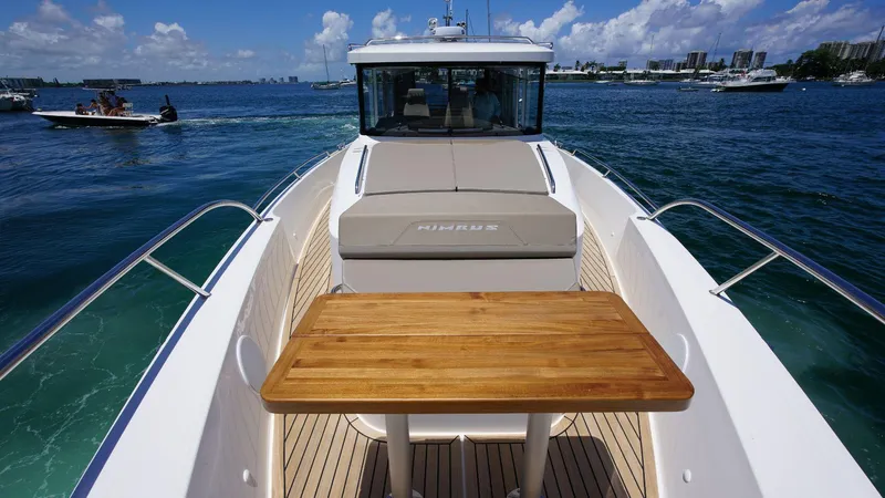In-stock 2024 Nimbus C11 #082 Yacht Photos Pics 2024 Nimbus Commuter 11 #082 boat with wooden deck table on open water.