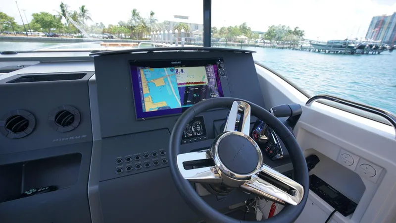 In-stock 2024 Nimbus C11 #082 Yacht Photos Pics Dashboard of 2024 Nimbus Commuter 11 #082 boat with navigation screen and steering wheel.