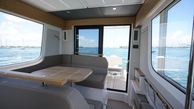 In-stock 2024 Nimbus C11 #082 Yacht Photos Pics Interior of 2024 Nimbus Commuter 11 #082 boat with ocean view through windows.