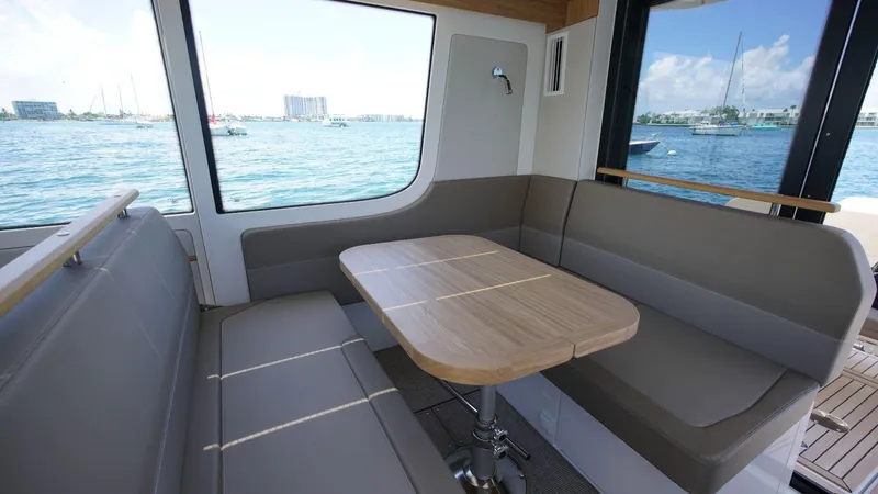 In-stock 2024 Nimbus C11 #082 Yacht Photos Pics 2024 Nimbus Commuter 11 #082 interior dining area with waterfront view.