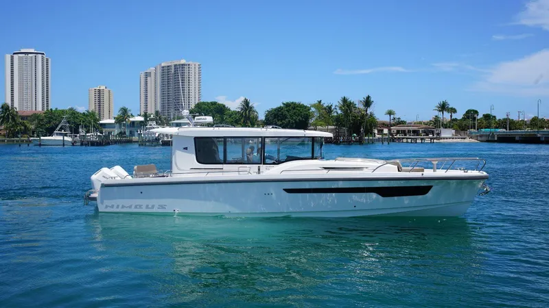 In-stock 2024 Nimbus C11 #082 Yacht Photos Pics 2024 Nimbus Commuter 11 #082 boat on water with city skyline background.