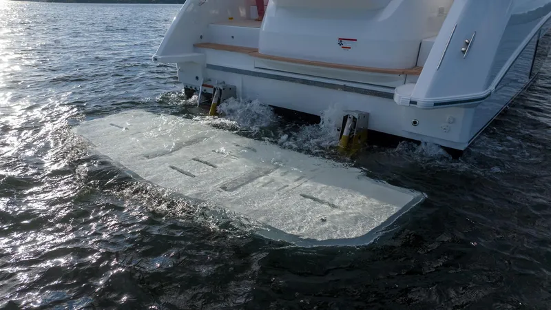 In Stock Yacht Photos Pics 2024 Beneteau Gran Turismo 45 yacht with hydraulic swim platform in water.