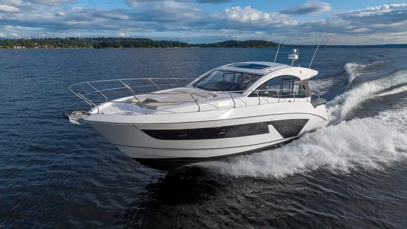 In Stock Yacht Photos Pics 2024 Beneteau Gran Turismo 45 yacht cruising on open water under a blue sky.