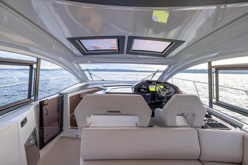 In Stock Yacht Photos Pics 2024 Beneteau Gran Turismo 45 yacht interior with panoramic windows and modern helm.