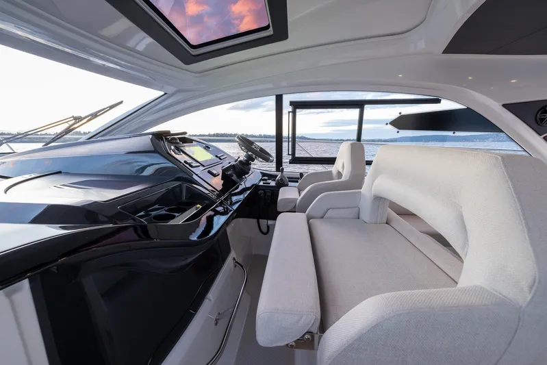 In Stock Yacht Photos Pics 2024 Beneteau Gran Turismo 45 yacht interior with modern helm and seating.