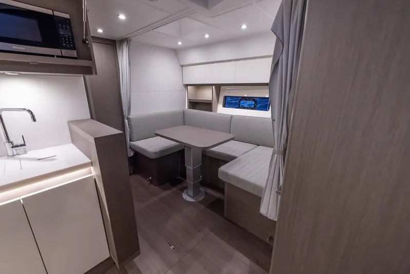 In Stock Yacht Photos Pics 2024 Beneteau Gran Turismo 45 interior with modern kitchen and cozy dining area.