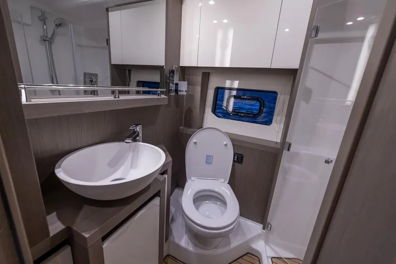 In Stock Yacht Photos Pics 2024 Beneteau Gran Turismo 45 yacht bathroom with modern fixtures and compact design.