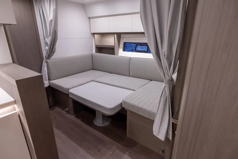 In Stock Yacht Photos Pics 2024 Beneteau Gran Turismo 45 interior with cozy seating and modern design.