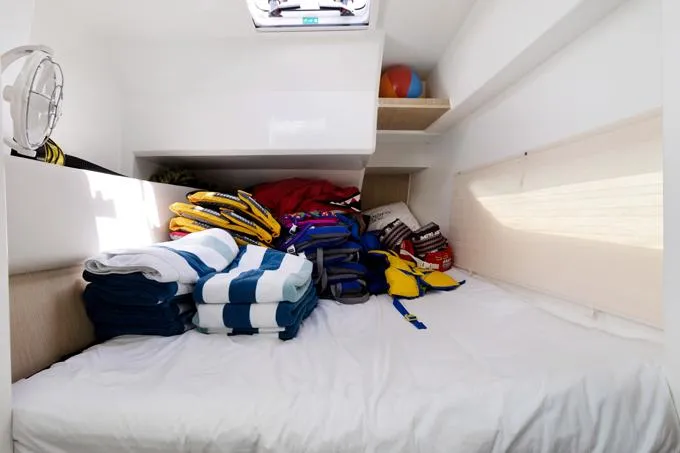Escape Yacht Photos Pics Interior cabin of 2022 Aquila 36 Sport with life jackets and towels.