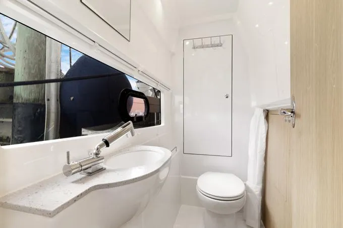 Escape Yacht Photos Pics Modern bathroom interior in 2022 Aquila 36 Sport yacht, featuring sleek design and fixtures.