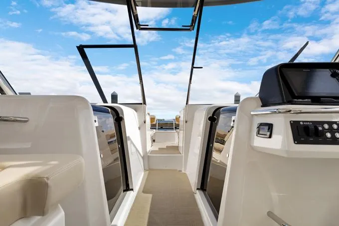 Escape Yacht Photos Pics Interior view of 2022 Aquila 36 Sport boat with open deck and clear sky.
