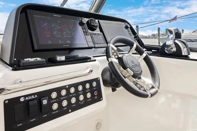 Escape Yacht Photos Pics Aquila 36 Sport 2022 boat dashboard with steering wheel and navigation controls.