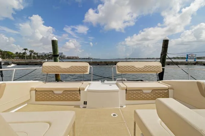 Escape Yacht Photos Pics Aquila 36 Sport 2022 boat interior with beige seating, docked by the water.