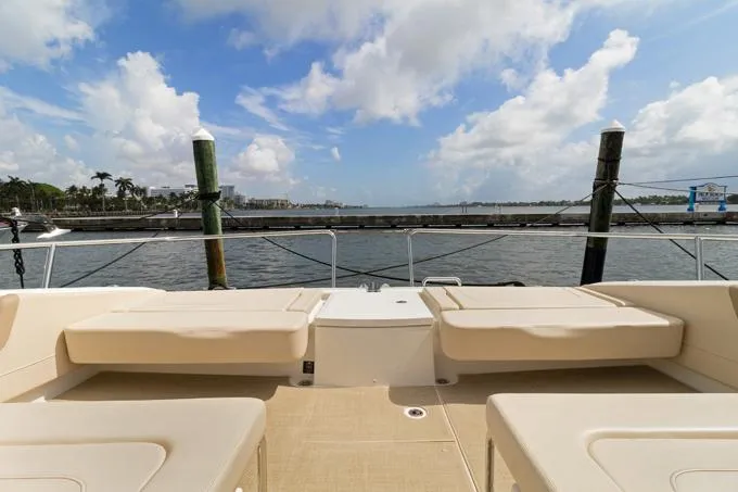 Escape Yacht Photos Pics Aquila 36 Sport 2022 yacht deck with seating, overlooking a scenic waterfront.