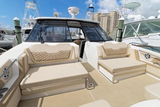 Escape Yacht Photos Pics Aquila 36 Sport 2022 yacht interior with beige seating at a marina.