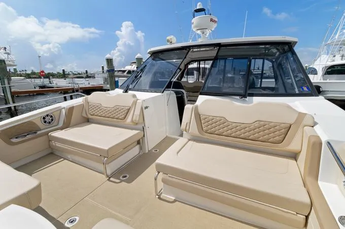 Escape Yacht Photos Pics Aquila 36 Sport 2022 yacht with beige seating and sleek design at a marina.