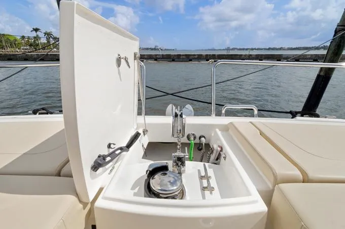 Escape Yacht Photos Pics Aquila 36 Sport 2022 yacht deck with open storage compartment and scenic water view.