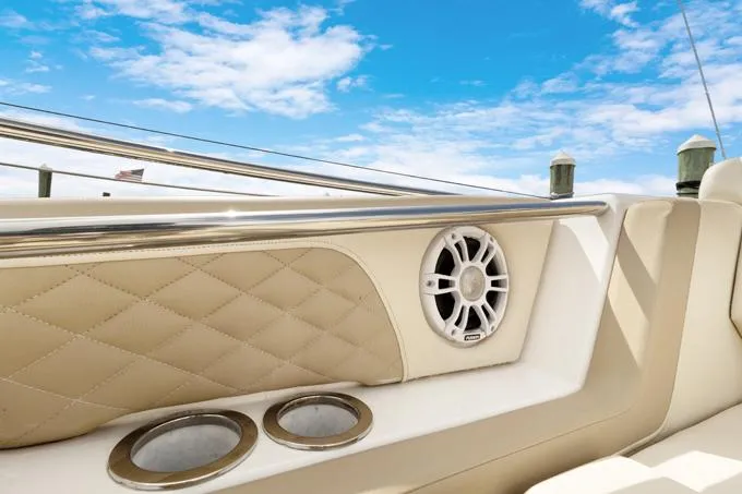 Escape Yacht Photos Pics 2022 Aquila 36 Sport boat interior with speaker and cup holders, under a clear blue sky.