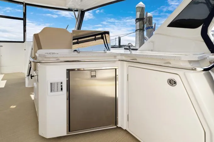 Escape Yacht Photos Pics Aquila 36 Sport 2022 yacht interior with sleek kitchenette and stainless steel appliances.
