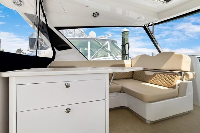 Escape Yacht Photos Pics Interior of 2022 Aquila 36 Sport yacht with beige seating and white cabinetry.